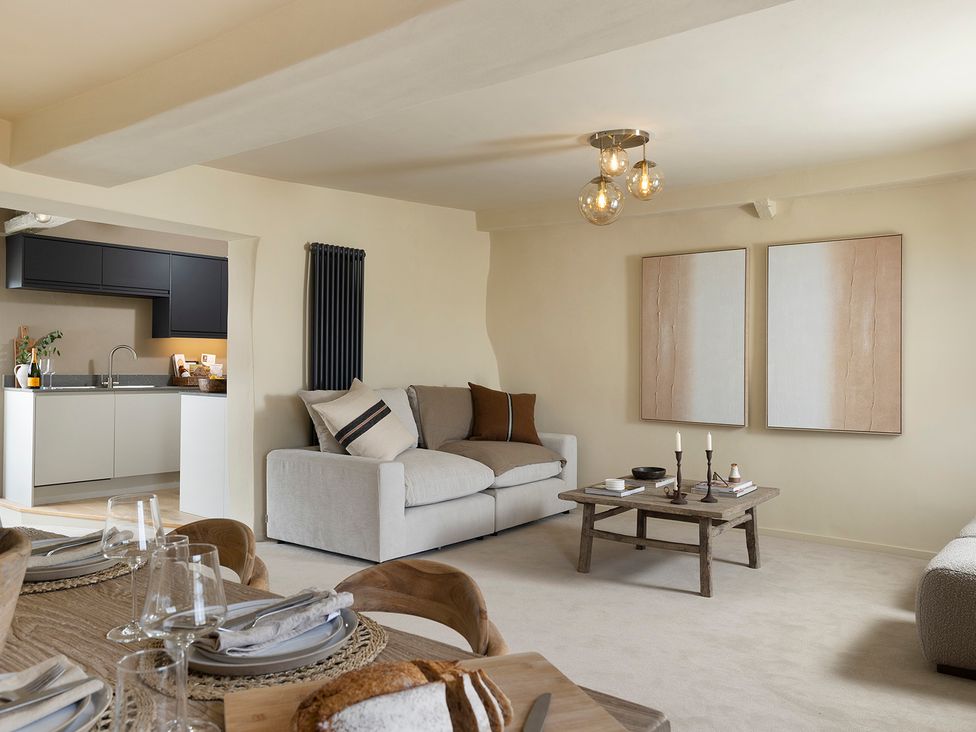 A living room with a sofa and coffee table at Church Alley House in Stow-On-The-Wold