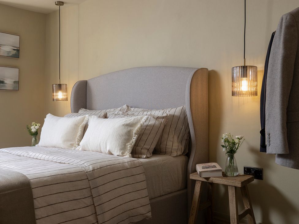 A bedroom with a bed and side table at Church Alley House, Stow-On-The-Wold