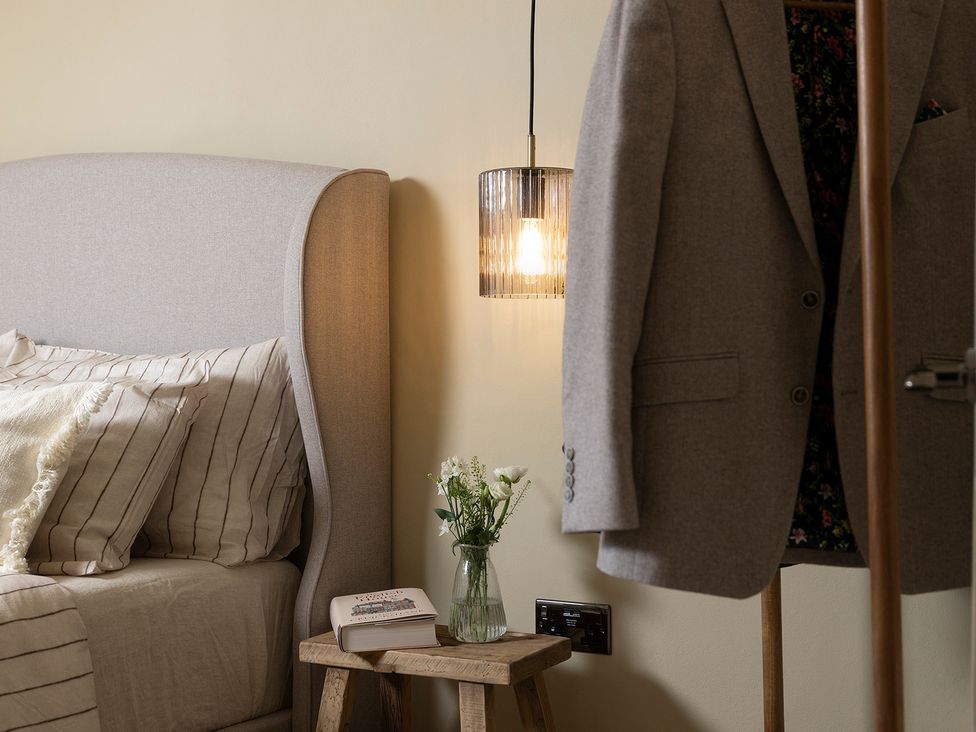A bedroom with a bed and lamp at Church Alley House, Stow-On-The-Wold