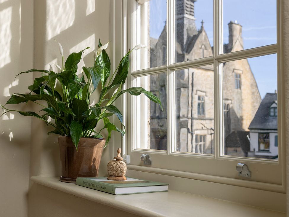 A plant and a book on a windowsill at Church Alley House Stow-On-The-Wold