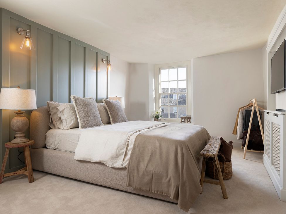 A bedroom with a bed and television at Church Alley House Stow-On-The-Wold