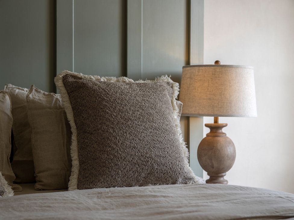 A bedroom with pillows and a lamp at Church Alley House in Stow-On-The-Wold