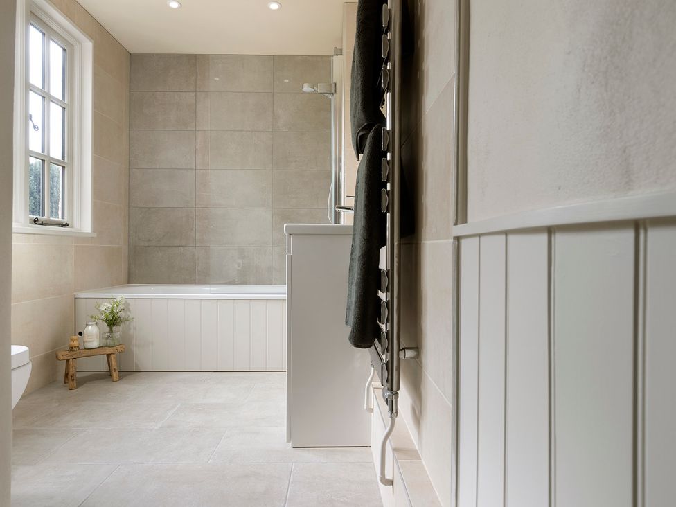 A bathroom with a bathtub, toilet, and sink at Church Alley House in Stow-On-The-Wold