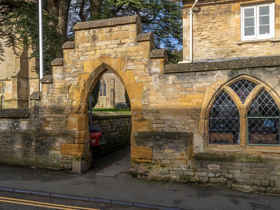 An arched doorway in a stone wall at Church Alley House in Stow-On-The-Wold