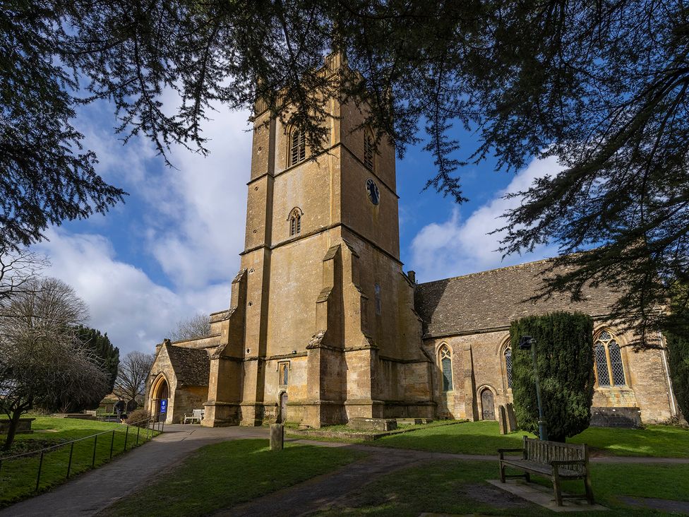 A church building with a tower and pathway at Church Alley House Stow-On-The-Wold