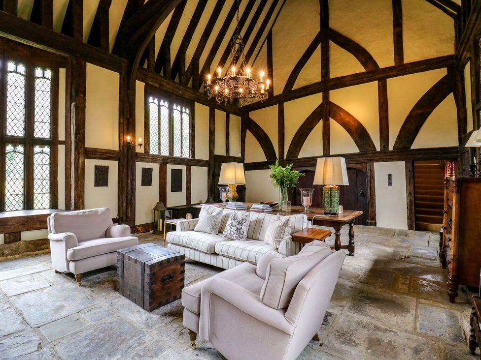 A living room with a chandelier and sofa at Dukes Place 