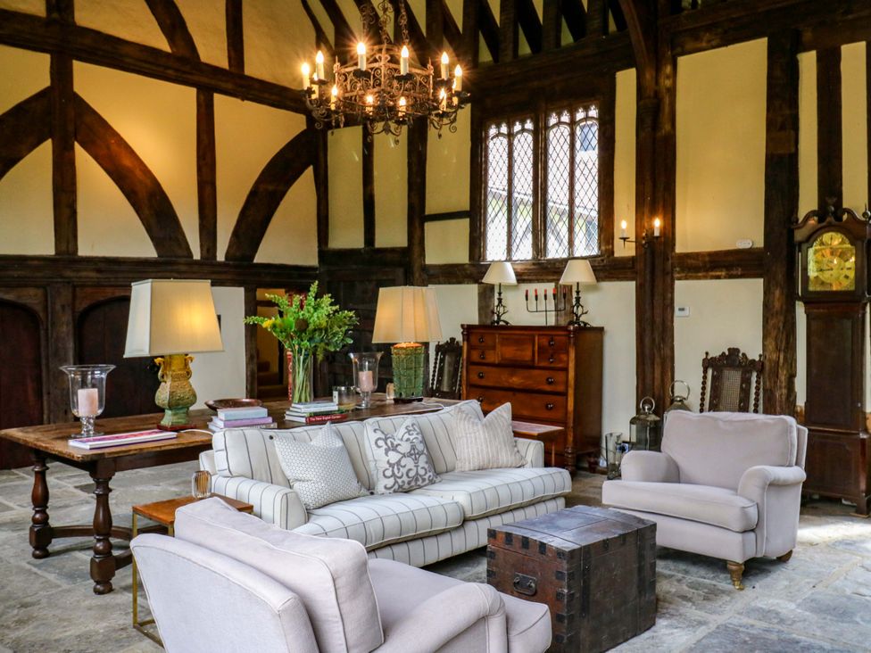 A living room with a chandelier and wooden furniture at Dukes Place