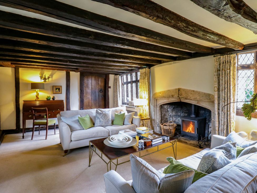 A living room with a fireplace and sofa at Dukes Place