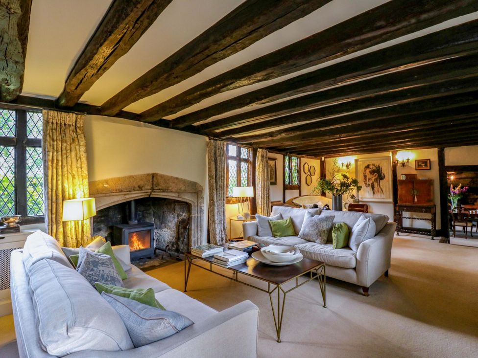 A living room with a fireplace and sofas at Dukes Place