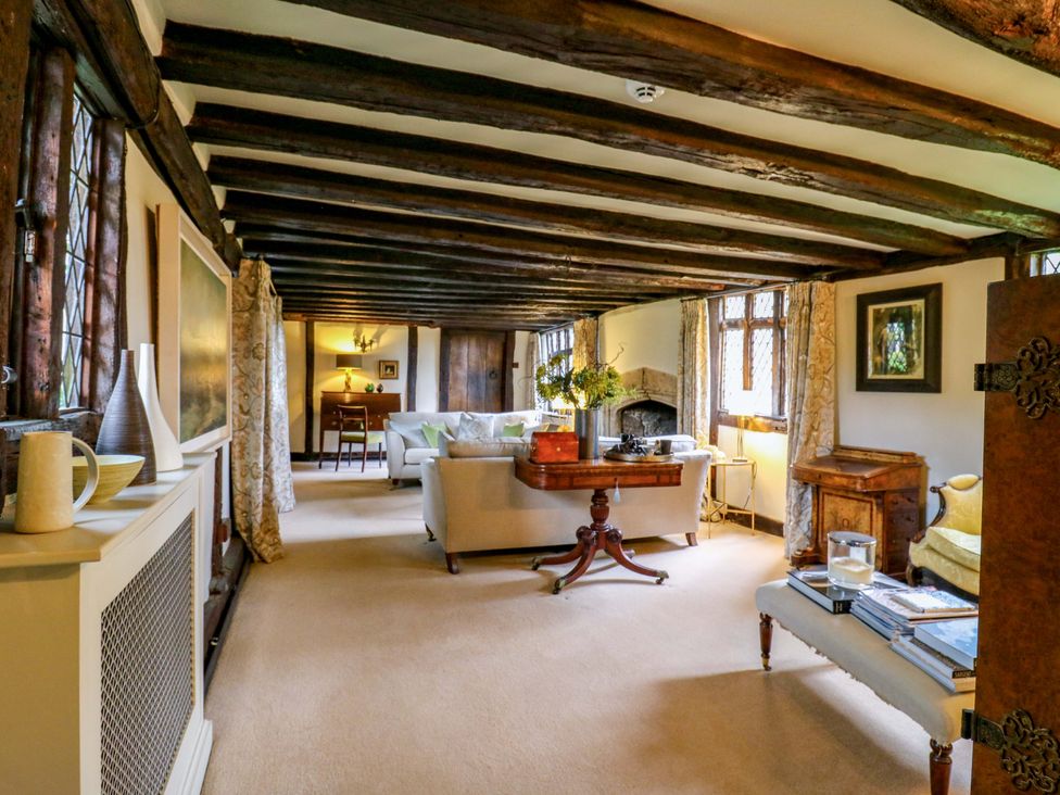 A living room with a fireplace and seating area at Dukes Place
