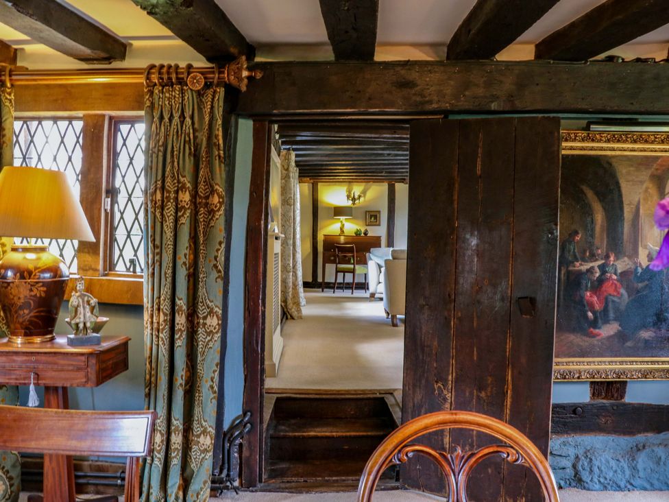 A living room with a table and lamp seen through a doorway at Dukes Place 
