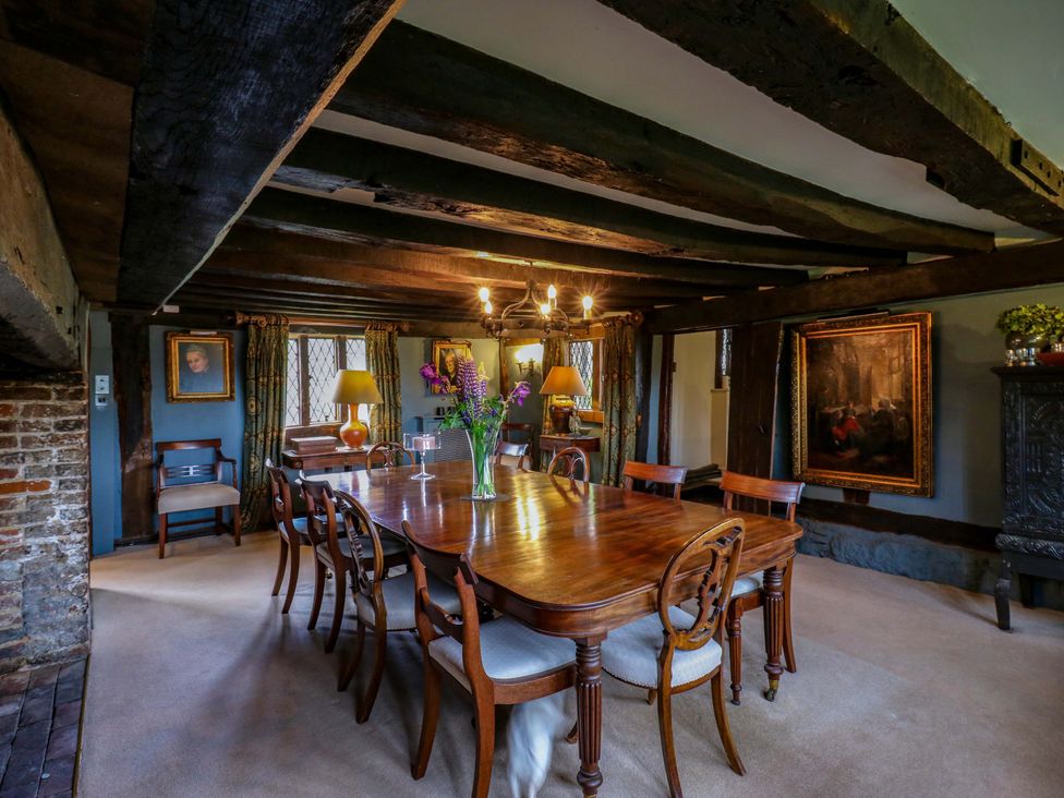 A dining room with a wooden table and chairs at Dukes Place