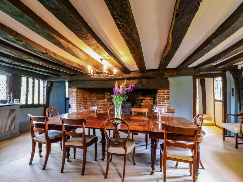 A dining room with a wooden table and chairs at Dukes Place