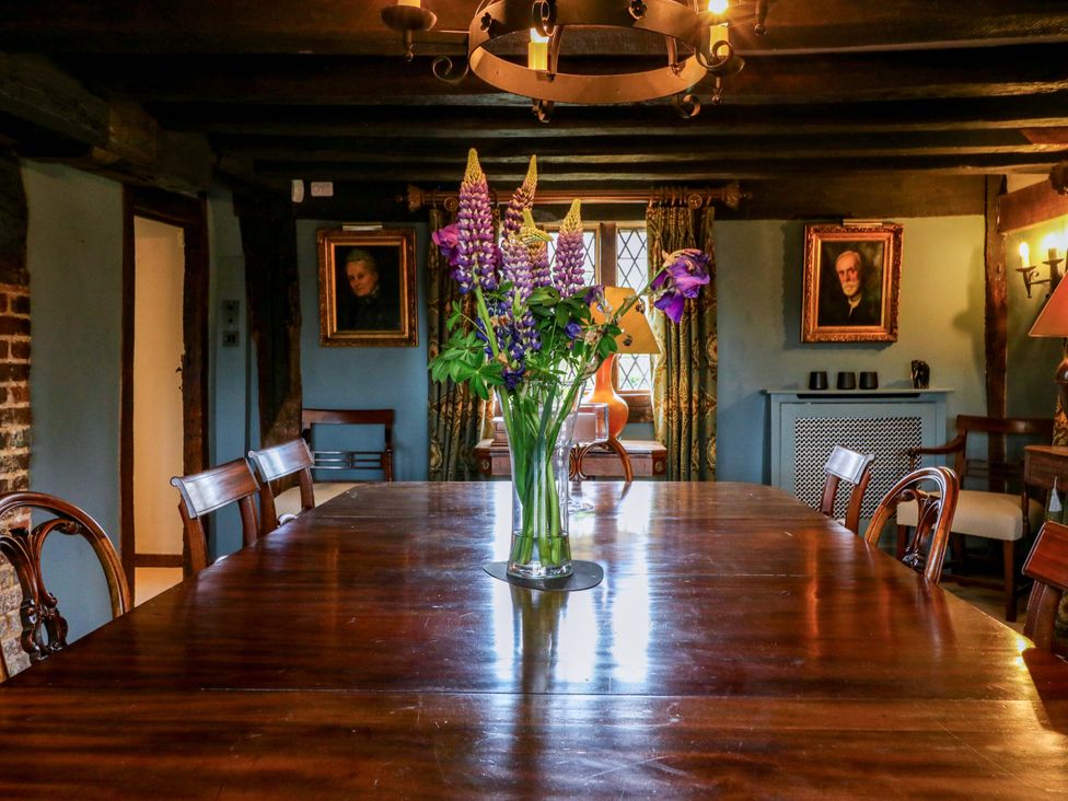 A dining room with a table and floral arrangement at Dukes Place