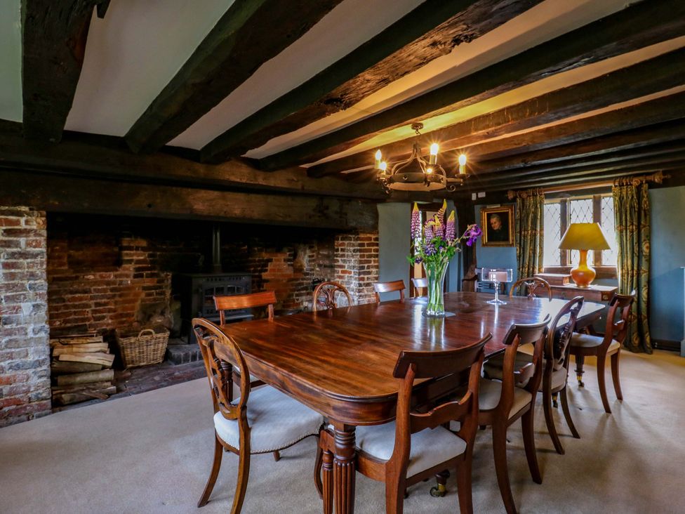 A dining room with a large table and fireplace at Dukes Place
