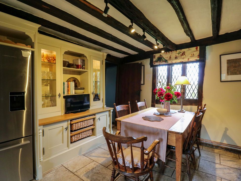 A dining room with a table and chairs at Dukes Place