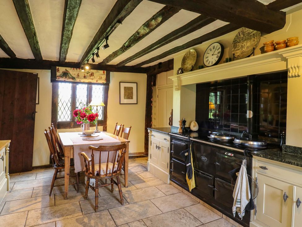 A kitchen with a dining table and stove at Dukes Place