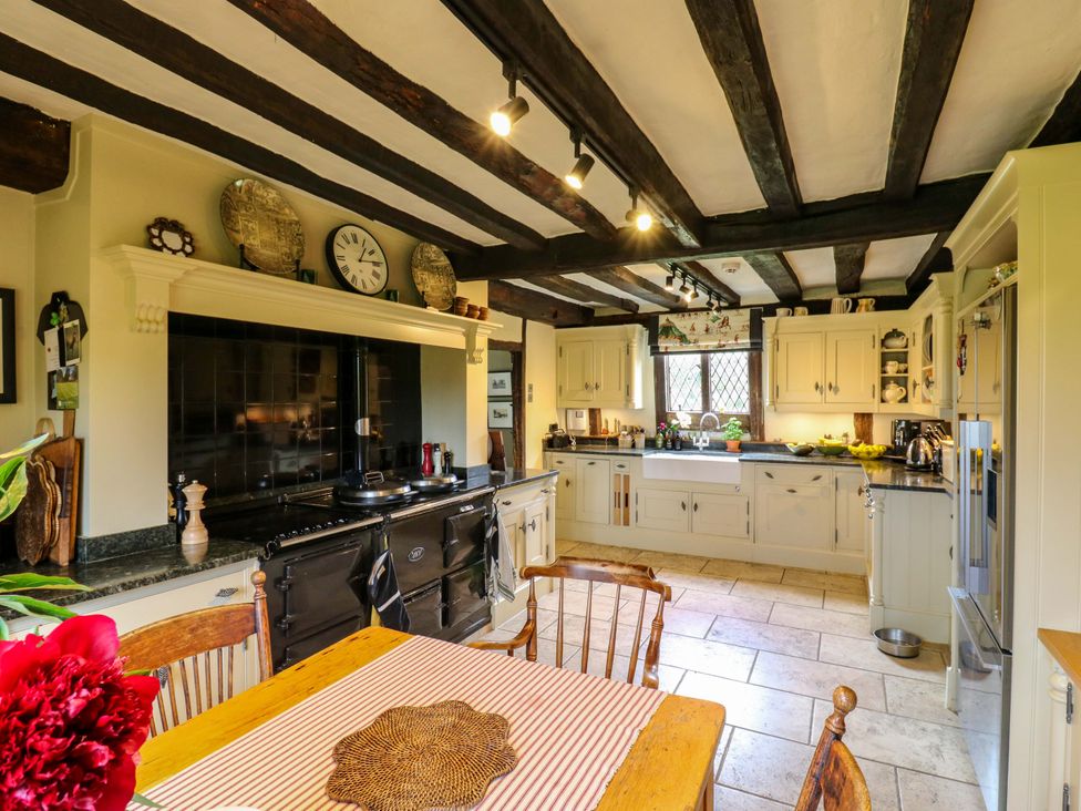 A kitchen with cabinets, sink, and table at Dukes Place