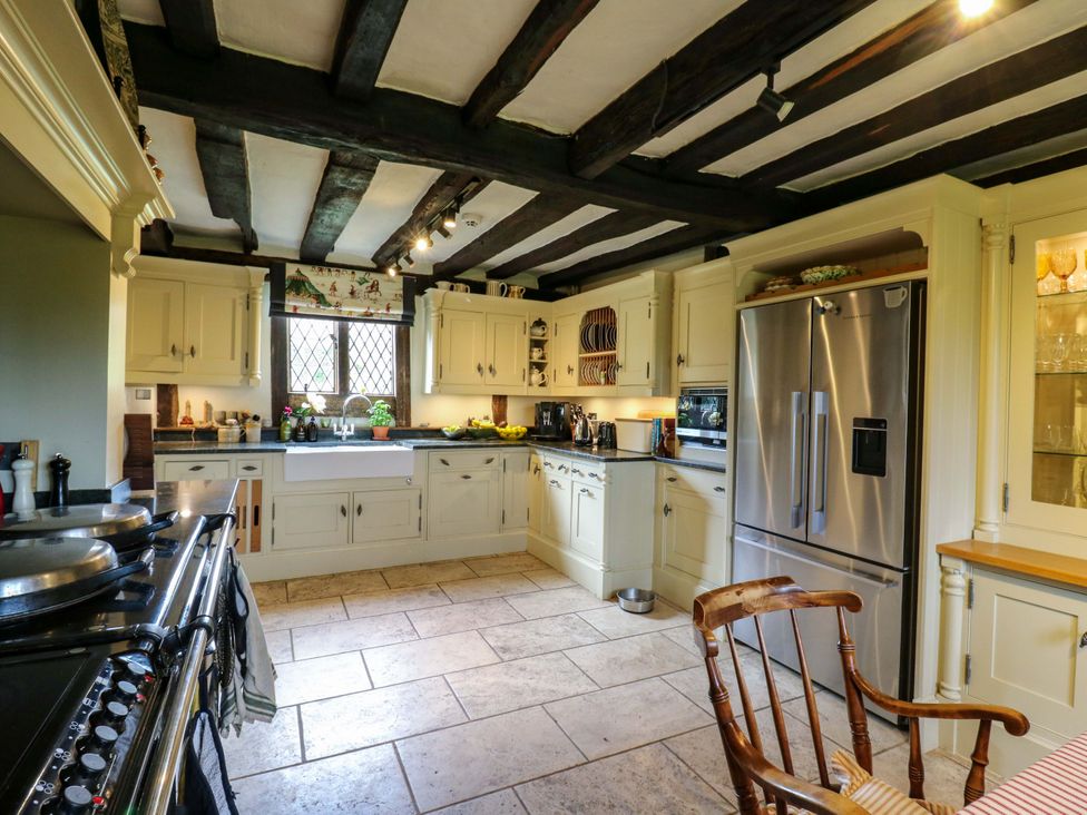 A kitchen with cabinets and a stove at Dukes Place 