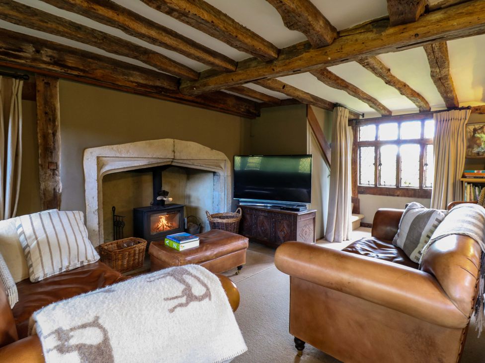 A living room with a fireplace and television at Dukes Place