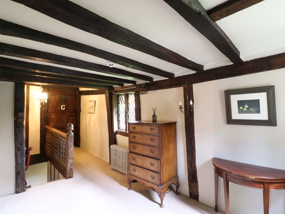 A hallway with wooden beams and furniture at Dukes Place