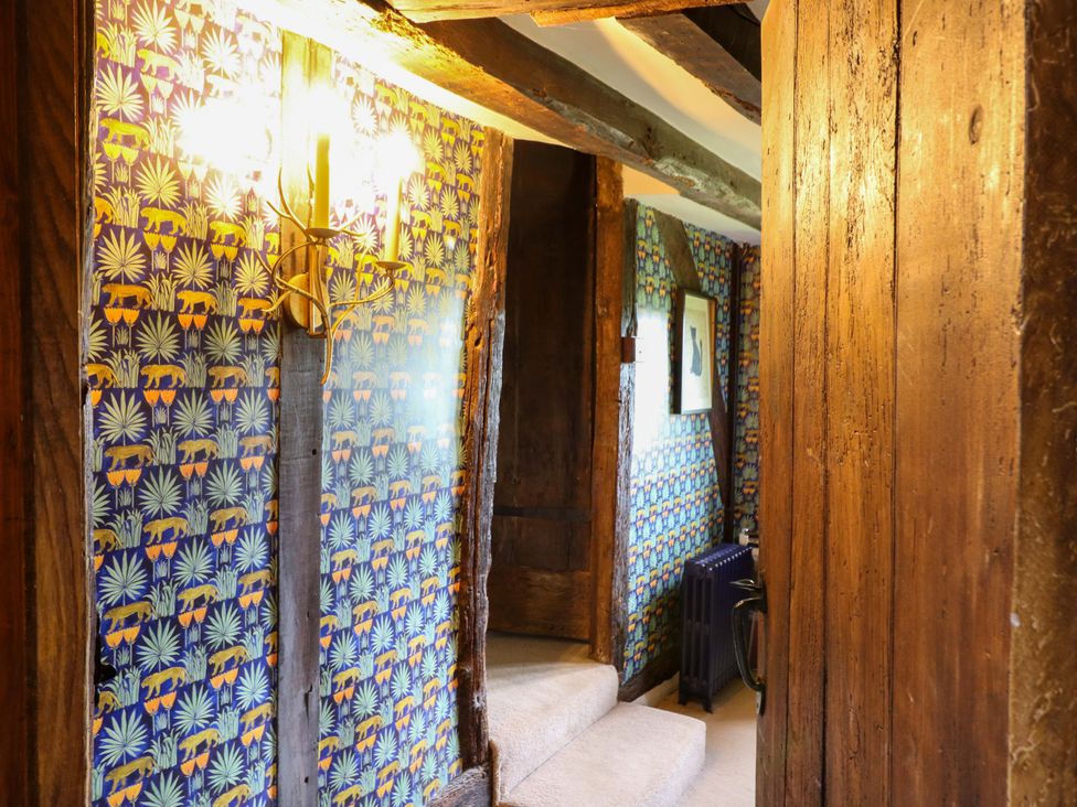 A hallway with wallpaper and wooden beams at Dukes Place