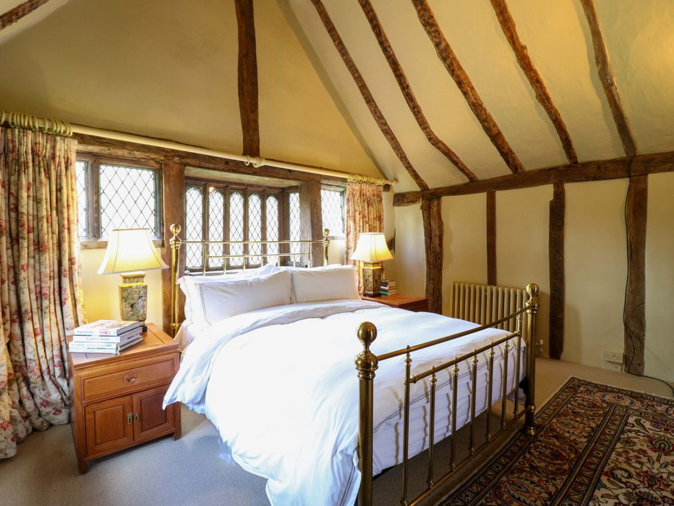 A bedroom with a brass bed and a nightstand at Dukes Place 