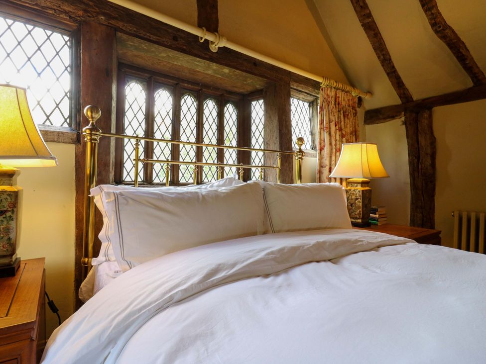 A bedroom with a bed and lamps at Dukes Place