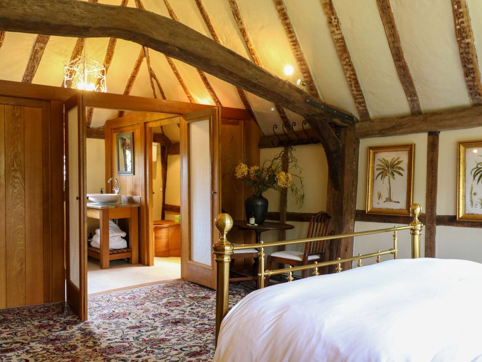 A bedroom with bed, sink, and chair at Dukes Place