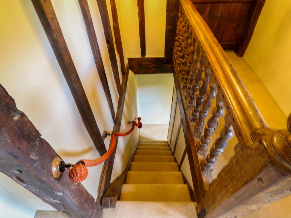 A staircase with wooden railing and carpet at Dukes Place