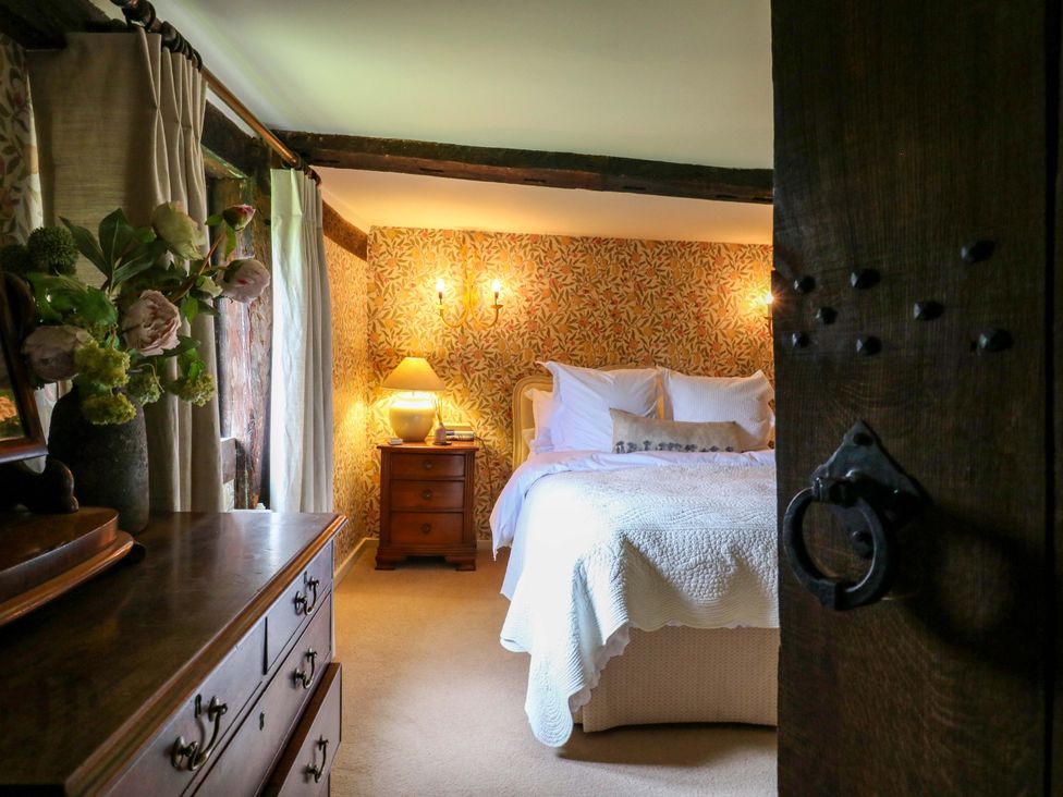 A bedroom with a bed and nightstand at Dukes Place