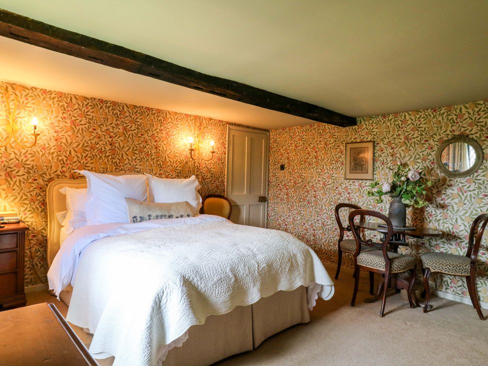 A bedroom with a bed and a small table at Dukes Place