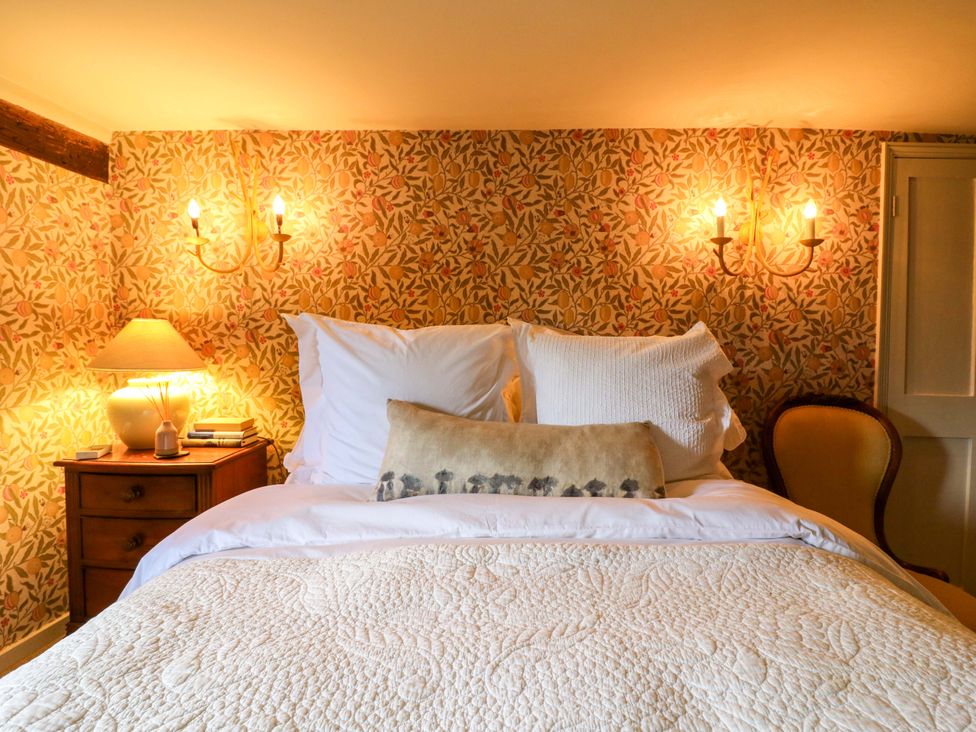 A bedroom with a bed and nightstand at Dukes Place