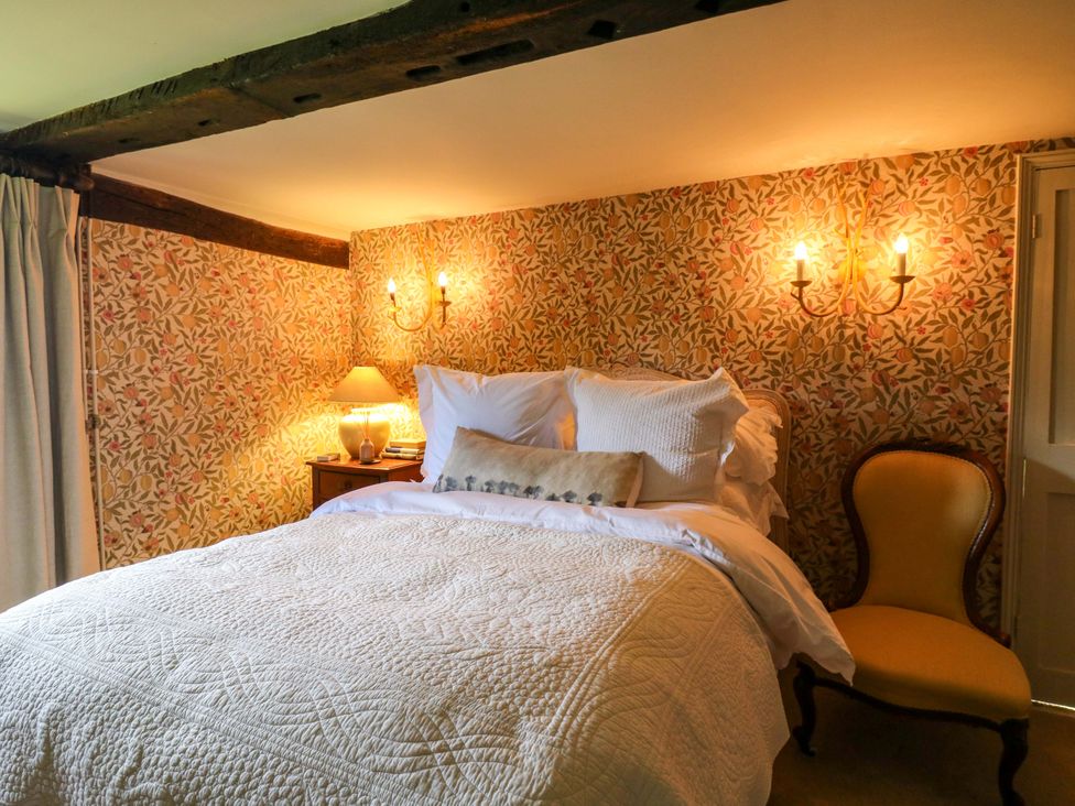 A bedroom with a bed and a chair at Dukes Place