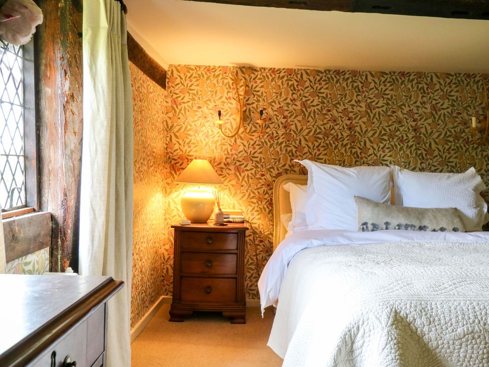 A bedroom with a bed and nightstand at Dukes Place