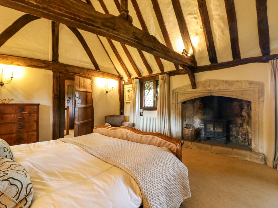 A bedroom with a bed and a fireplace at Dukes Place in 