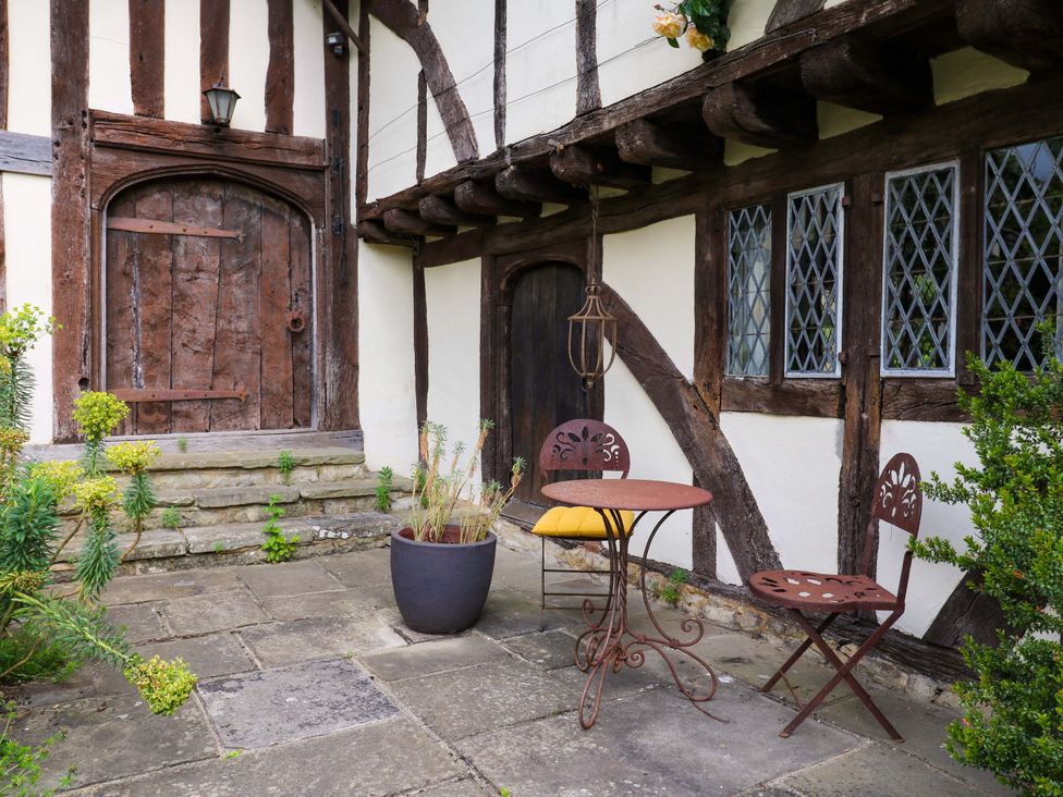 An outdoor patio with a table and chairs at Dukes Place