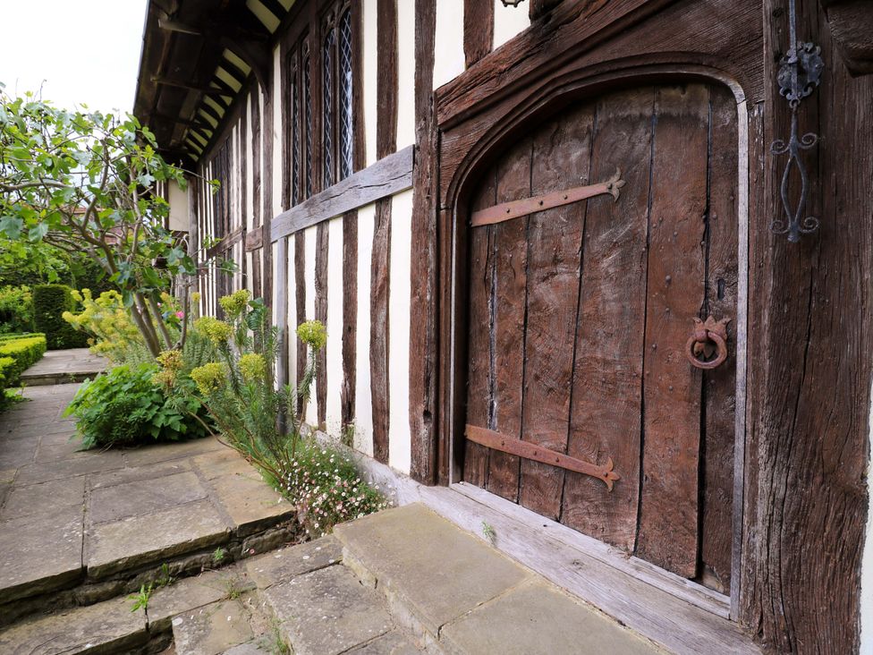 A stone path leading to a wooden door in the garden at Dukes Place