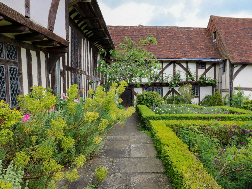 A garden with a path and flower beds at Dukes Place