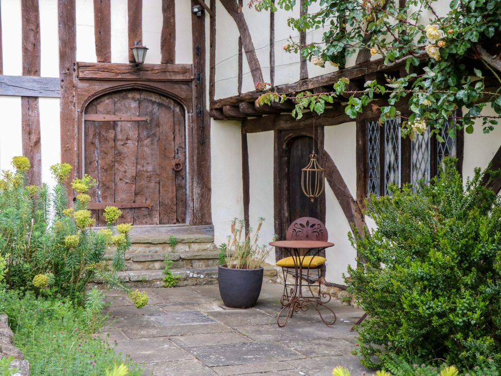 A patio with a door, window, and plants at Dukes Place
