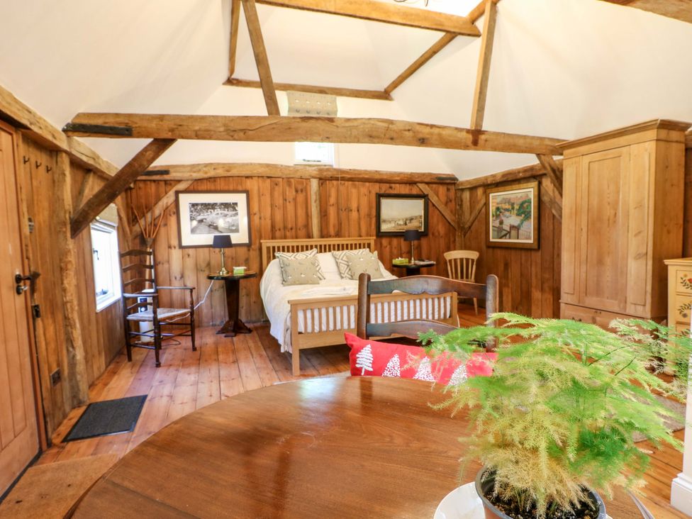 A bedroom with bed, table, and chairs at The Granary in Petworth