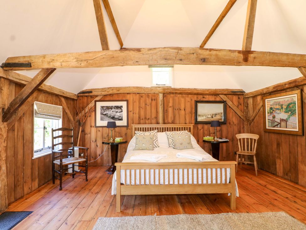 A bedroom with a bed and side table at The Granary in Petworth