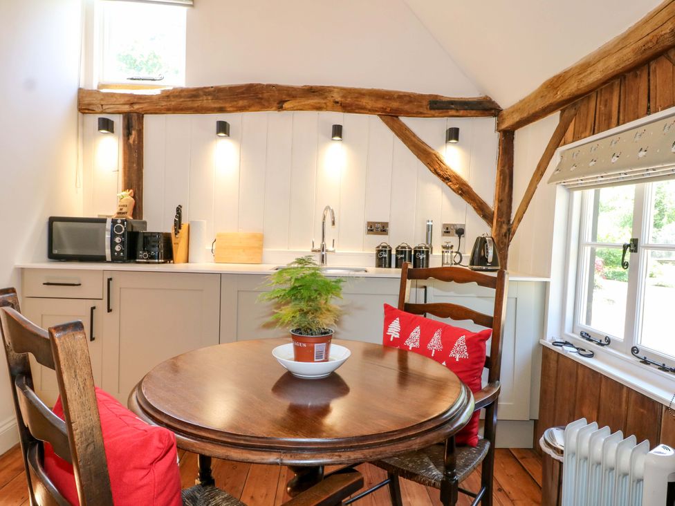 A kitchen with a table and chairs at The Granary in Petworth