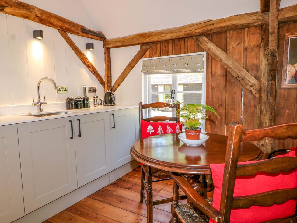 A kitchen with a sink and table at The Granary in Petworth