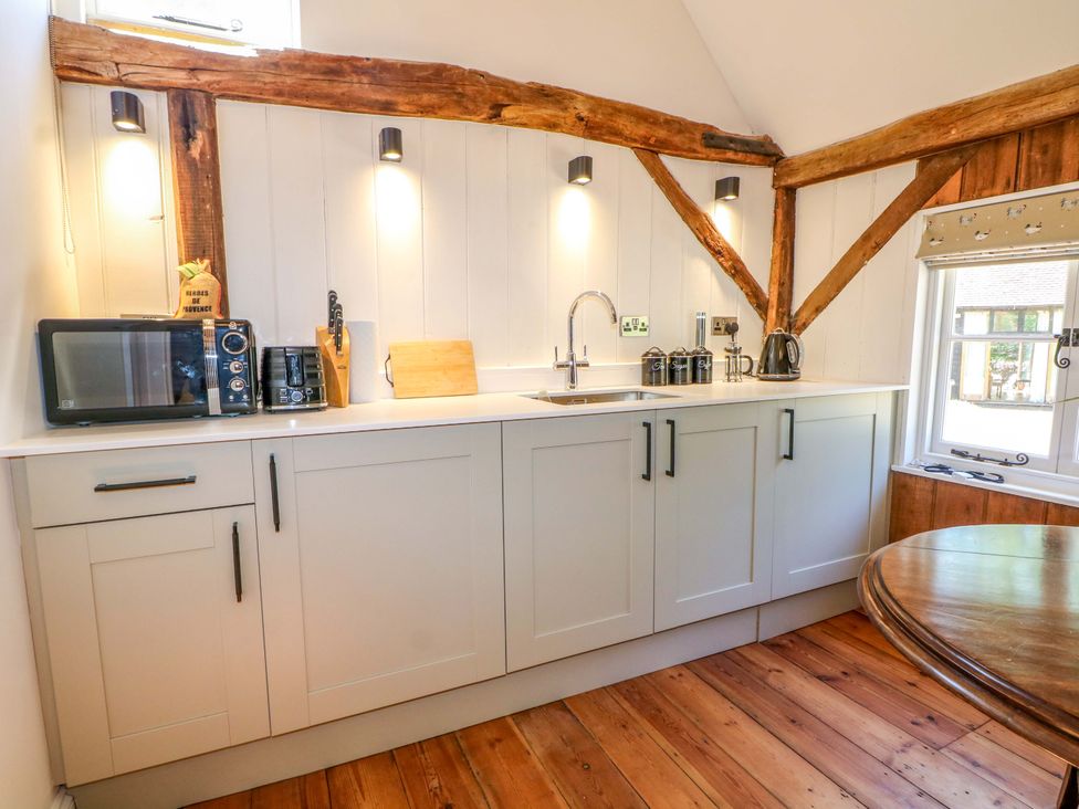 A kitchen with appliances and utensils at The Granary in Petworth