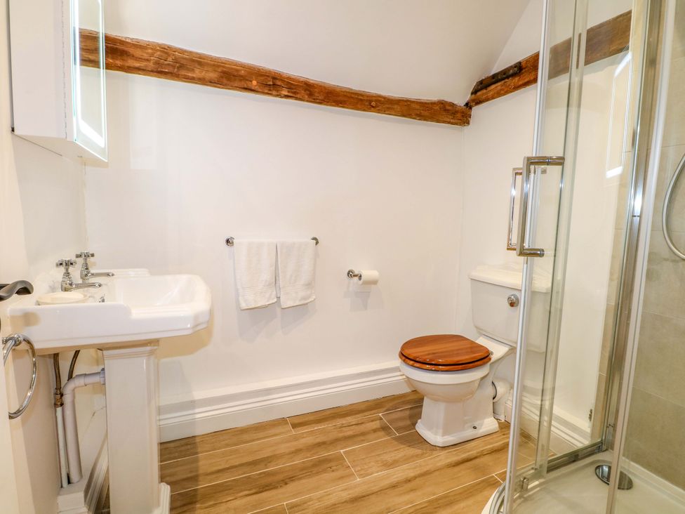 A bathroom with sink, toilet, and shower at The Granary in Petworth