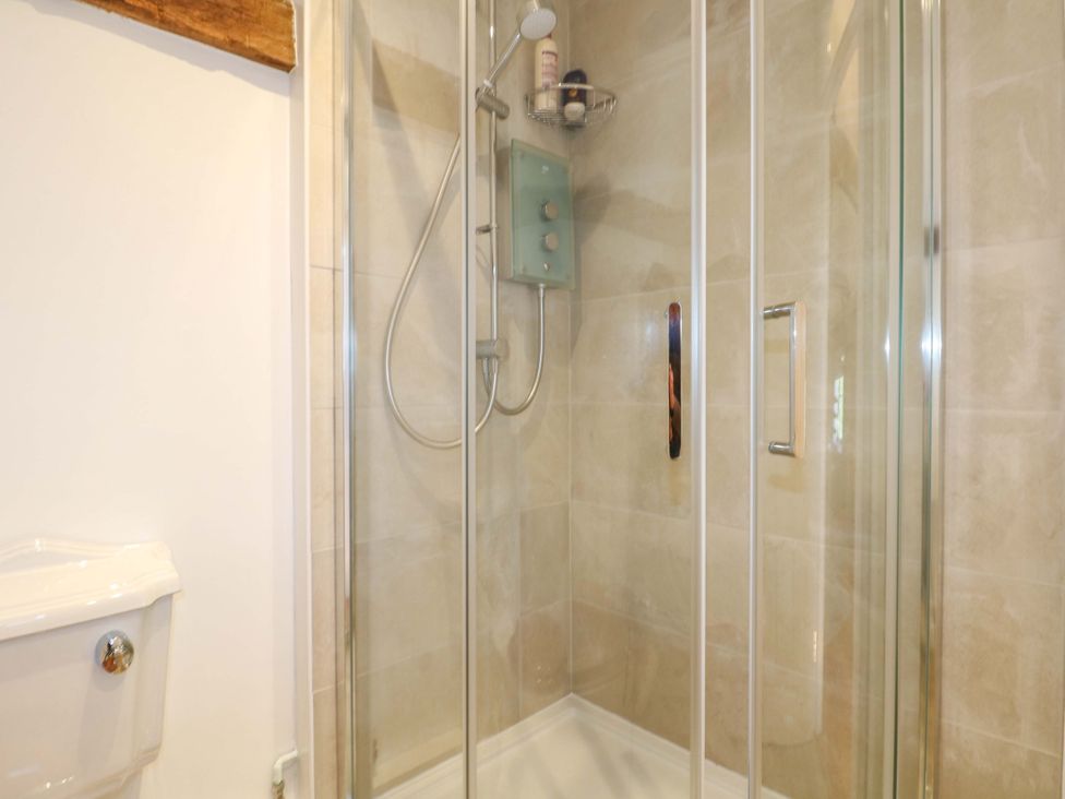 A shower enclosure with a toilet in the bathroom at The Granary in Petworth