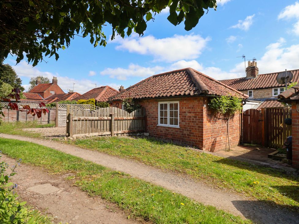 An outdoor view of a brick building with a pathway at The Cook’s Cottage in Malton