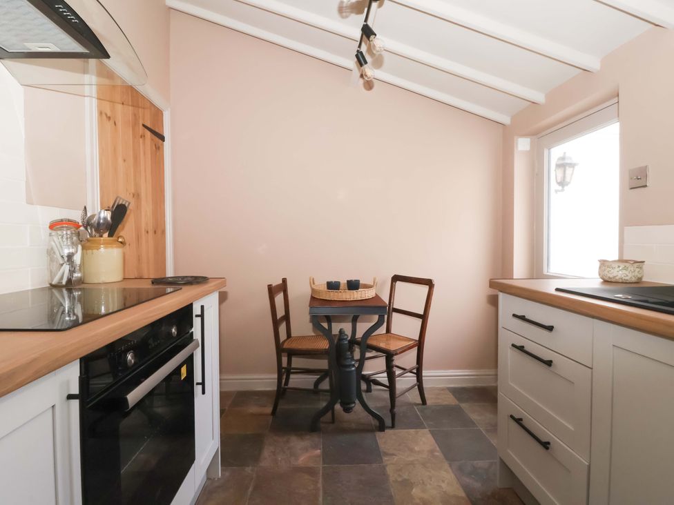 A kitchen with a table and chairs at The Cook’s Cottage in Malton