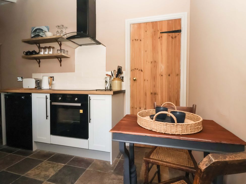 A kitchen with furniture and appliances at The Cook’s Cottage in Malton